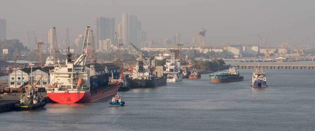 Cargo ships docking at a busy city port