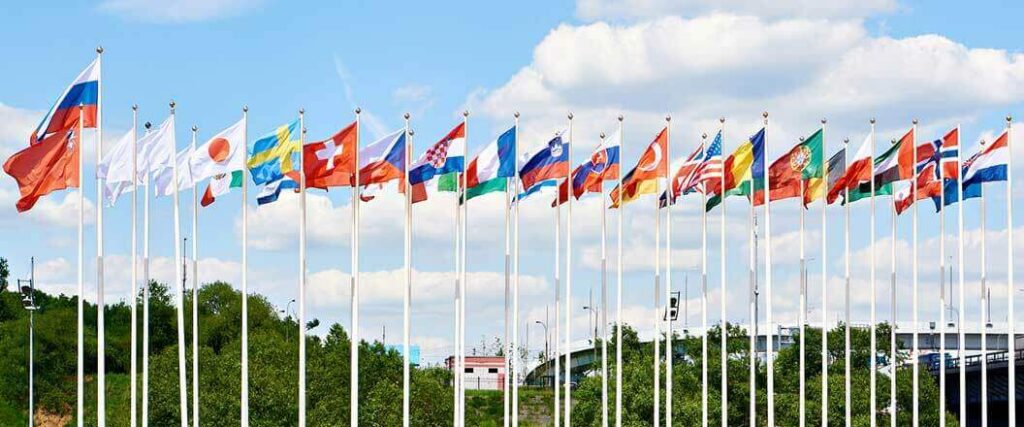 Flags of different nations all flying next to one another